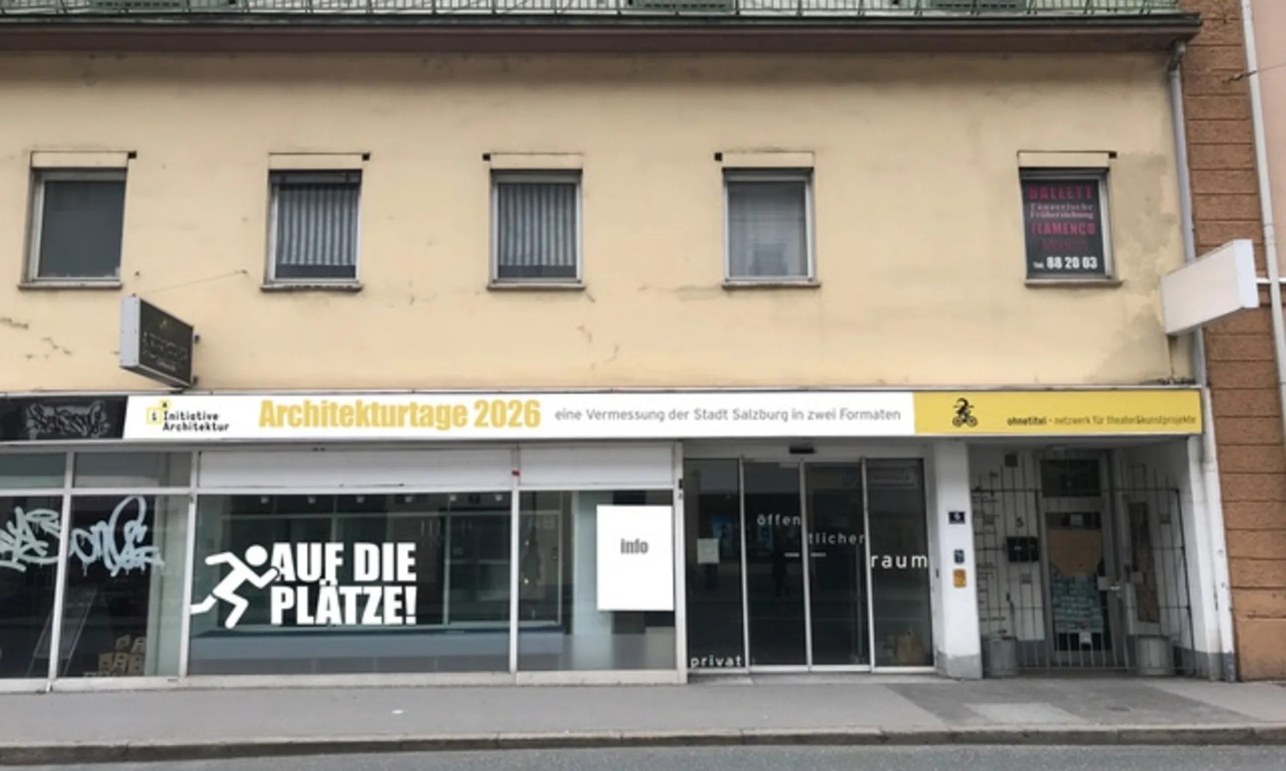 Eine gelbe Hausfassade, mittig auf der Fassade die Aufschrift Architekturtage 2026 in gelb